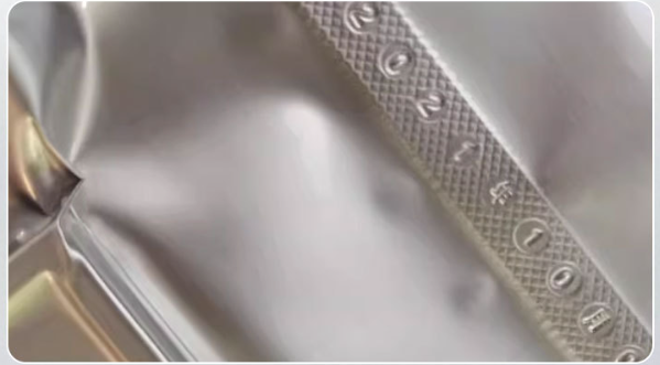 Close-up of vacuum seal with embossed date imprint on packaging bag